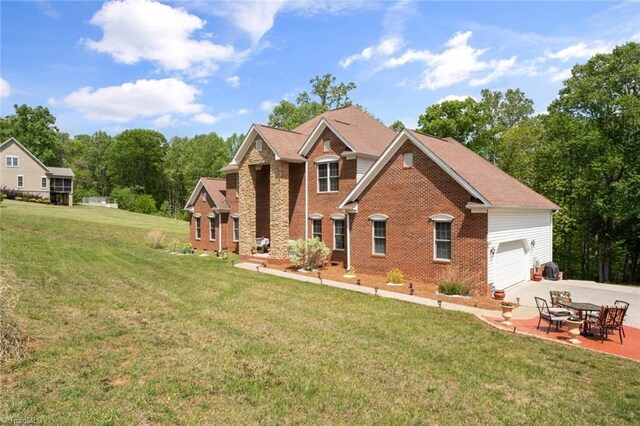 6065 Providence Church Rd, Winston-Salem, NC 27105 - view of front facade with a front lawn, concrete driveway, and brick siding