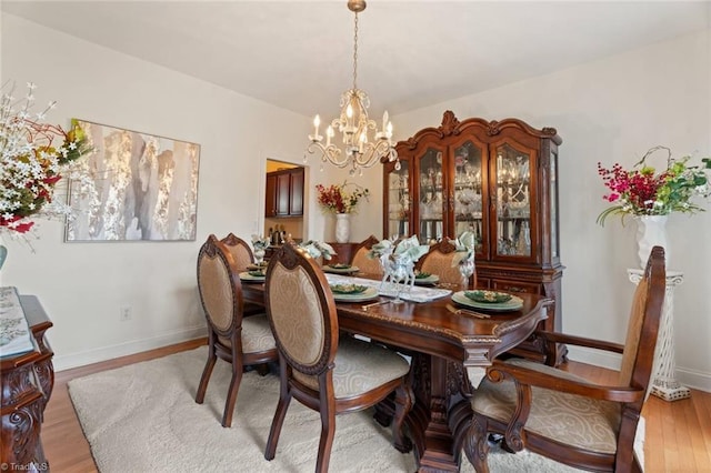 6065 Providence Church Rd, Winston-Salem, NC 27105 - dining space with a chandelier, light wood-style flooring, and baseboards