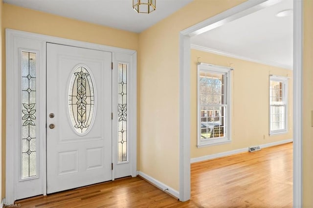 foyer entrance with light hardwood / wood-style floors