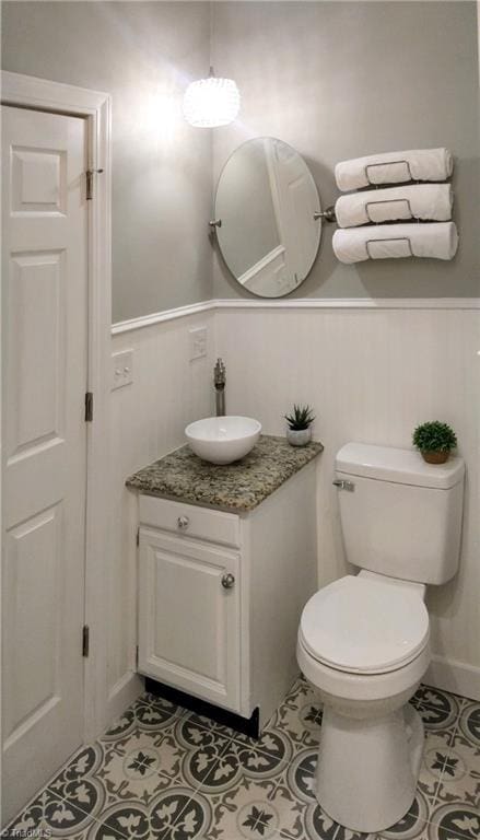 bathroom featuring vanity, tile patterned floors, and toilet