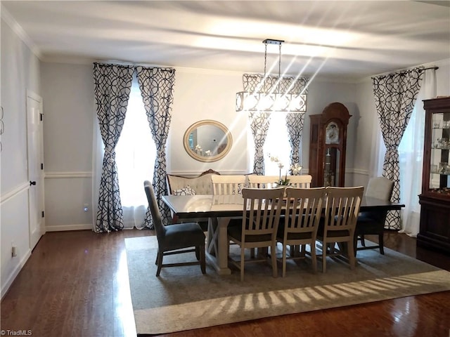 dining room featuring a healthy amount of sunlight, hardwood / wood-style floors, and an inviting chandelier