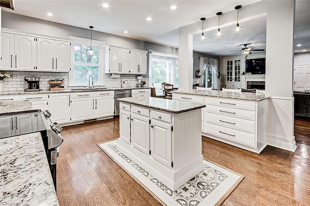 kitchen with plenty of natural light, ceiling fan, and hardwood / wood-style floors