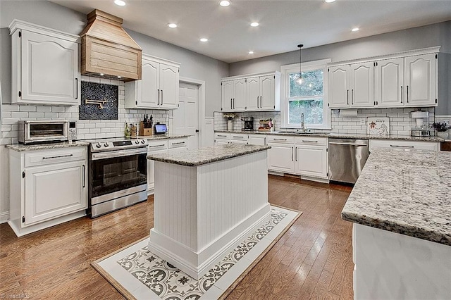 kitchen featuring appliances with stainless steel finishes and white cabinetry