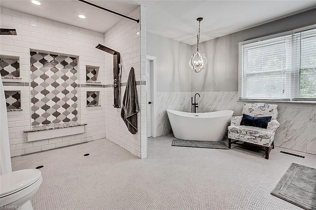 bathroom with tile walls, a tile shower, and toilet