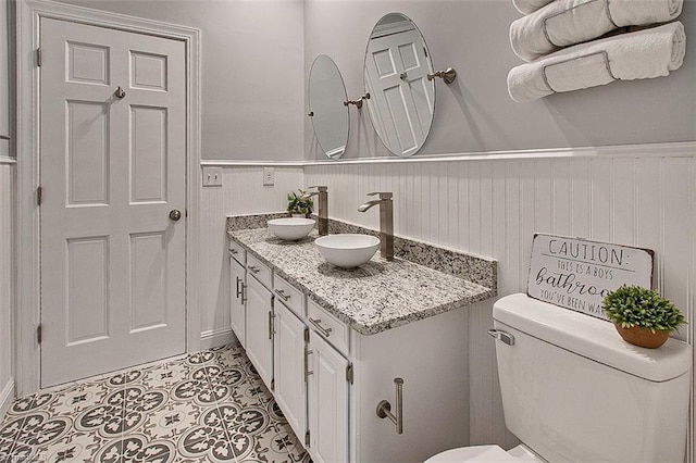 bathroom featuring tile patterned floors, vanity, and toilet