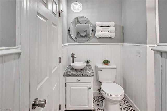 bathroom featuring tile patterned floors, toilet, and vanity