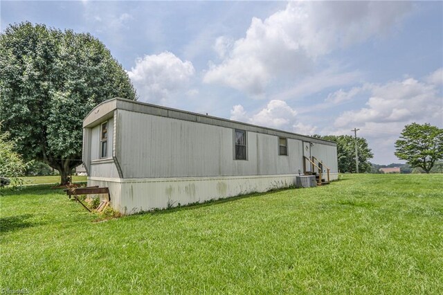 1105 Cabana Ln, East Bend, NC 27018 - view of side of home with a yard and central AC