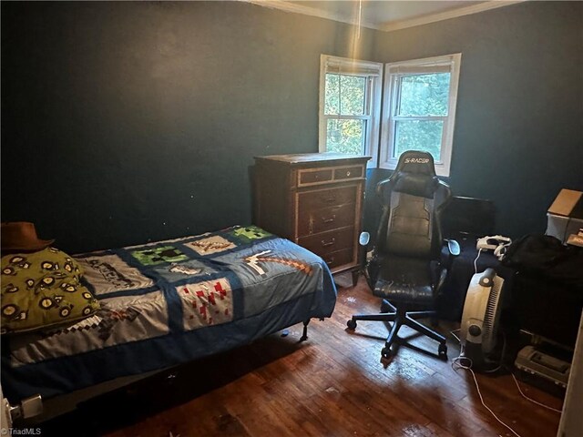 bedroom featuring dark hardwood / wood-style flooring and crown molding