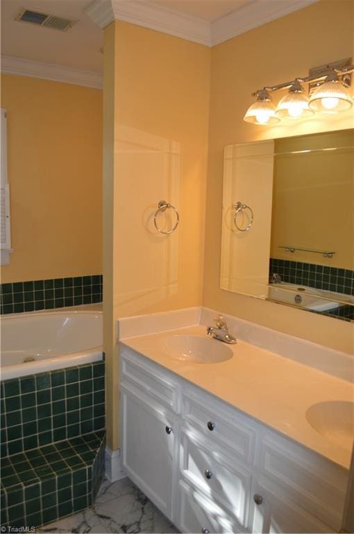 bathroom featuring vanity, ornamental molding, and tiled tub