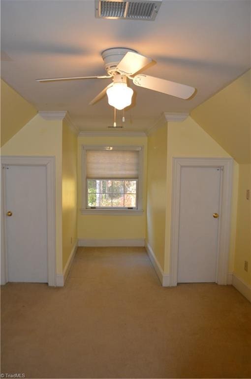 additional living space with light colored carpet and ceiling fan