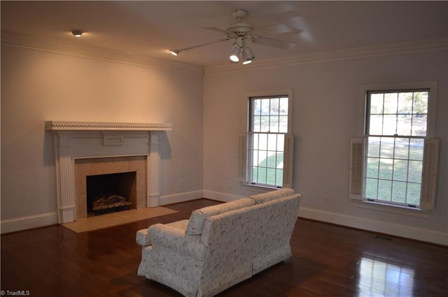 living room with dark hardwood / wood-style flooring, a healthy amount of sunlight, and crown molding