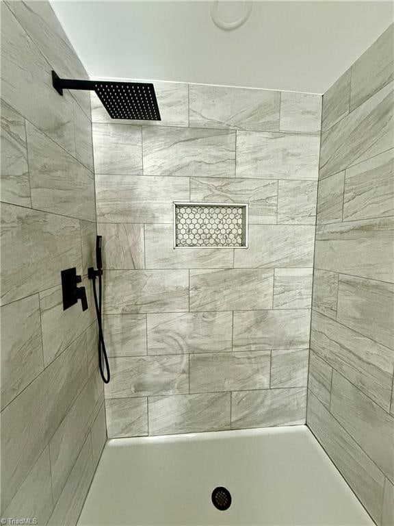 bathroom with tiled shower