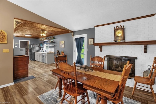 3809 Evergreen Dr, Trinity, NC 27370 - dining room featuring wood finished floors, a fireplace, and a ceiling fan
