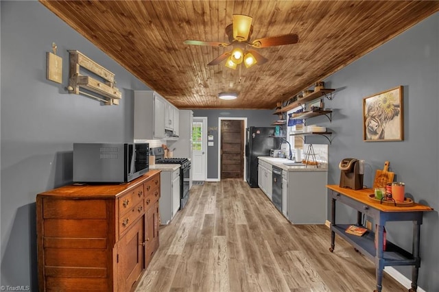 3809 Evergreen Dr, Trinity, NC 27370 - kitchen with appliances with stainless steel finishes, wooden ceiling, a ceiling fan, light countertops, and light wood-type flooring