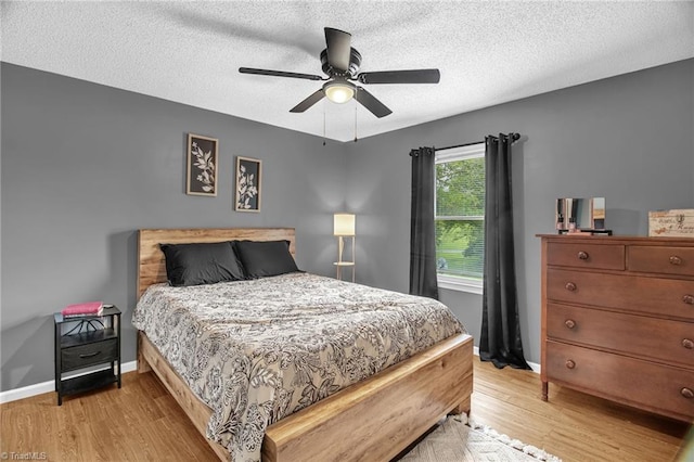 3809 Evergreen Dr, Trinity, NC 27370 - bedroom featuring light wood-style flooring, ceiling fan, and a textured ceiling