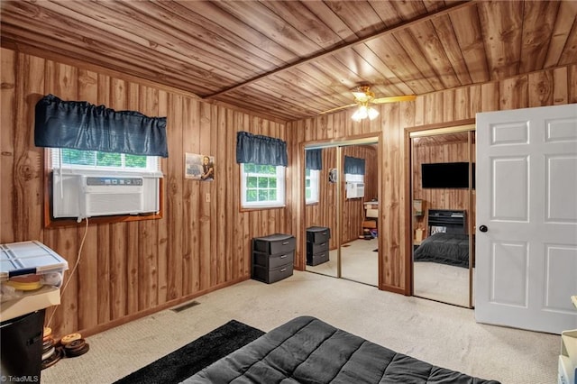 3809 Evergreen Dr, Trinity, NC 27370 - carpeted bedroom featuring multiple closets, cooling unit, wooden ceiling, and wooden walls
