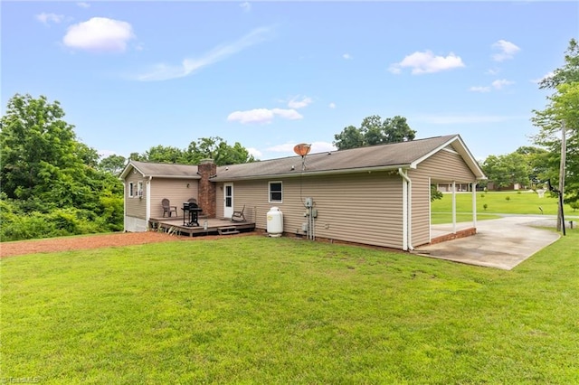 3809 Evergreen Dr, Trinity, NC 27370 - back of property featuring a deck, a patio area, a yard, and a chimney