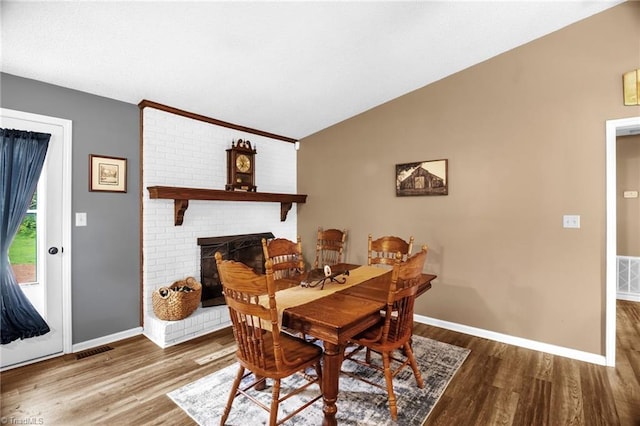 3809 Evergreen Dr, Trinity, NC 27370 - dining space with lofted ceiling, wood finished floors, and a fireplace