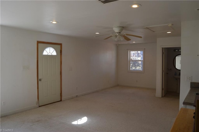 foyer entrance with recessed lighting, baseboards, a wealth of natural light, and light colored carpet