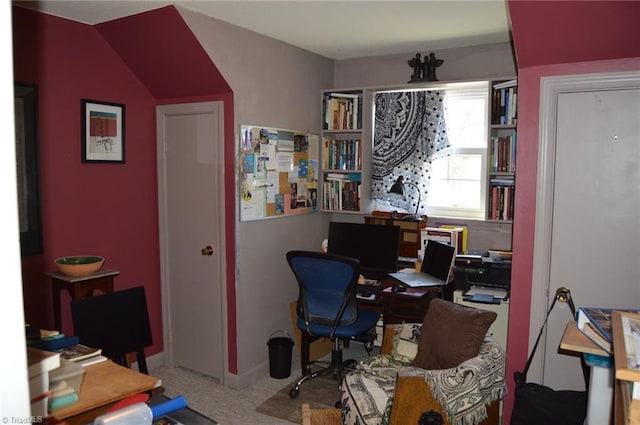 carpeted home office with baseboards