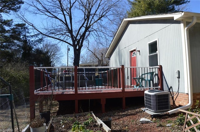 exterior space featuring cooling unit and a garden