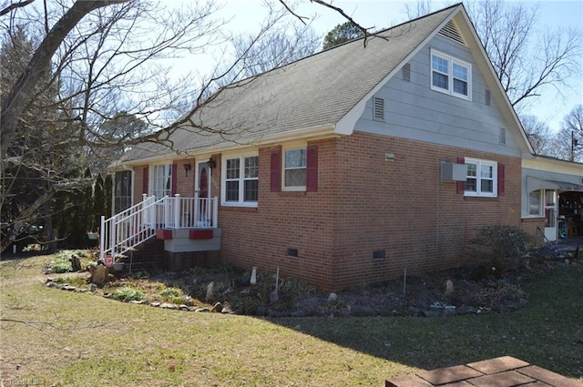 view of home's exterior with brick siding, crawl space, a shingled roof, and a lawn