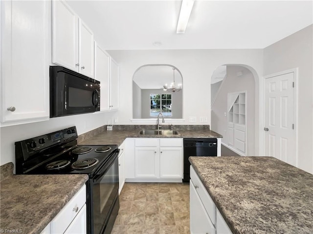 kitchen featuring sink, pendant lighting, white cabinets, and black appliances