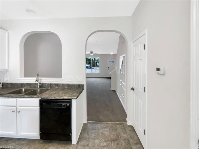 kitchen with black dishwasher, sink, carpet, and white cabinets