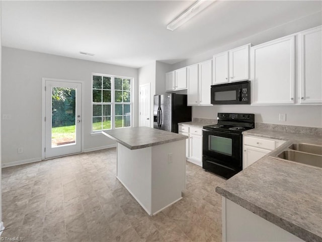 kitchen with white cabinetry, sink, black appliances, and a center island