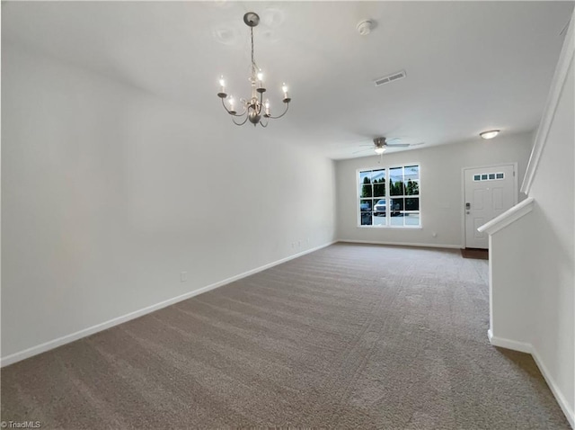 spare room with carpet and ceiling fan with notable chandelier