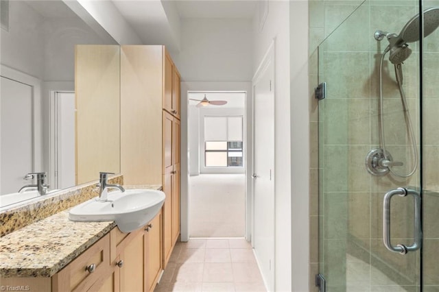 bathroom featuring a stall shower, vanity, tile patterned floors, and ceiling fan