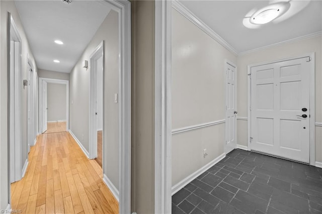 hallway with baseboards and ornamental molding