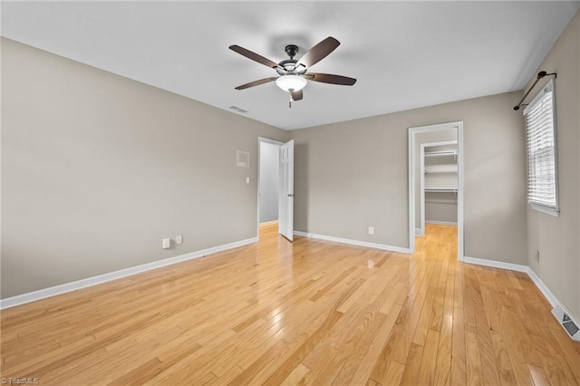 unfurnished bedroom featuring visible vents, baseboards, and light wood-style floors