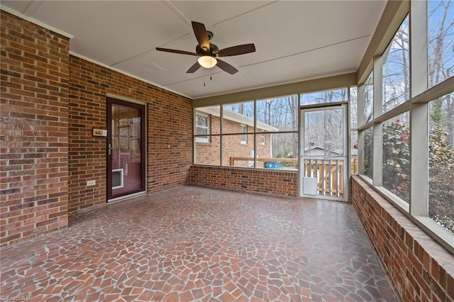 unfurnished sunroom with a wealth of natural light and ceiling fan