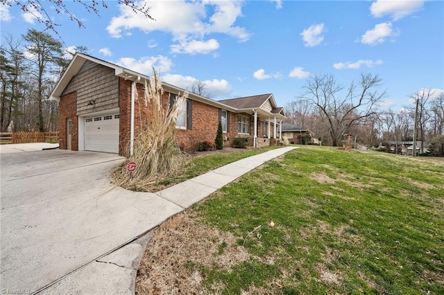 view of side of property with a lawn, concrete driveway, and brick siding