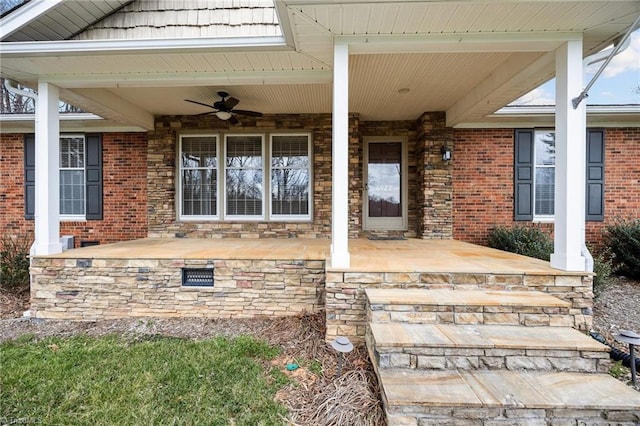 property entrance with ceiling fan, a porch, brick siding, and crawl space