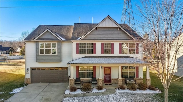 craftsman inspired home featuring brick siding, a porch, concrete driveway, an attached garage, and a front yard