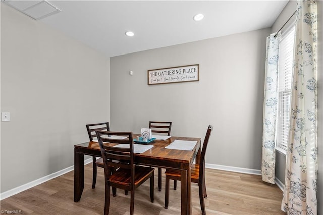 dining room with light wood-style floors, baseboards, and recessed lighting