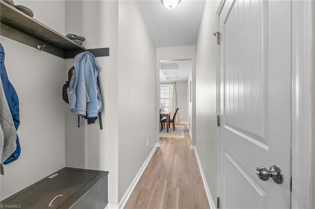 interior space featuring light wood-type flooring and baseboards