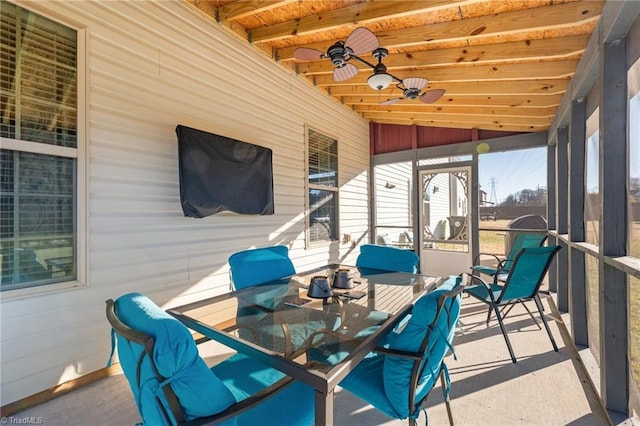 sunroom / solarium featuring a ceiling fan and lofted ceiling with beams