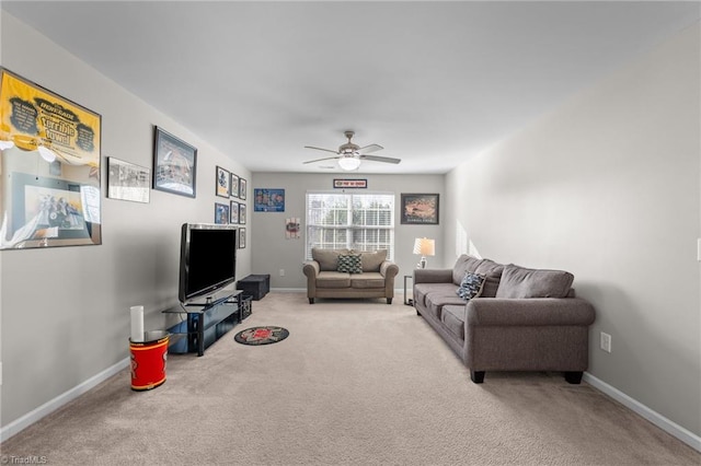 living room featuring light carpet, baseboards, and a ceiling fan