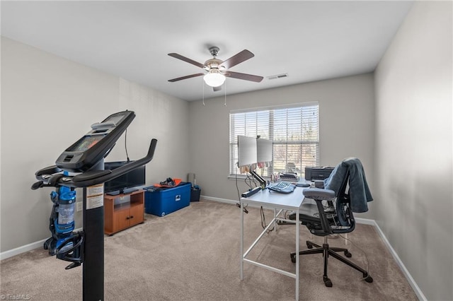 carpeted office with a ceiling fan, visible vents, and baseboards