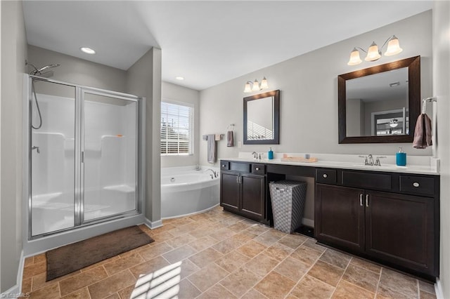 bathroom featuring double vanity, a stall shower, a sink, and a bath