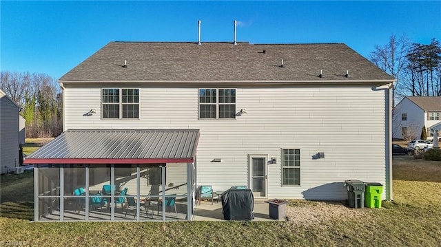 back of property featuring a sunroom, a patio area, and a yard