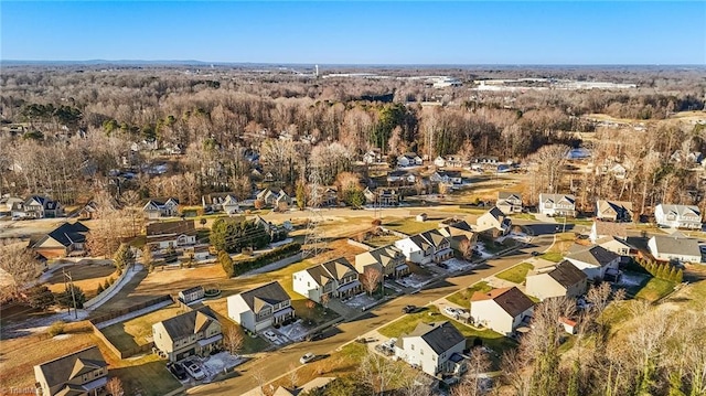 birds eye view of property featuring a residential view and a view of trees