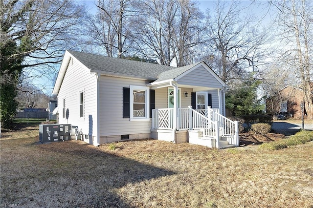 view of front facade with central AC unit and a front yard