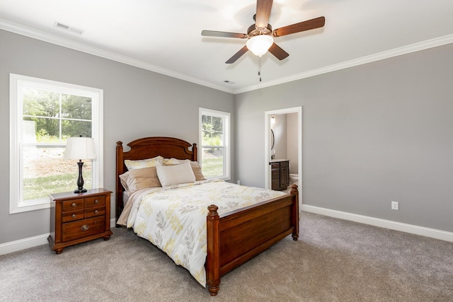 carpeted bedroom featuring ceiling fan, ensuite bath, multiple windows, and crown molding