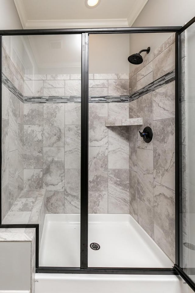 bathroom with ornamental molding and walk in shower