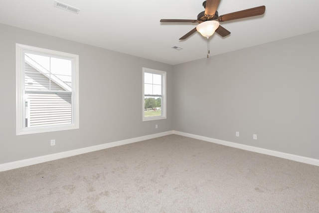 carpeted empty room featuring ceiling fan