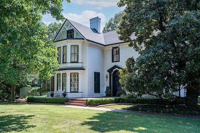 victorian home featuring a front yard